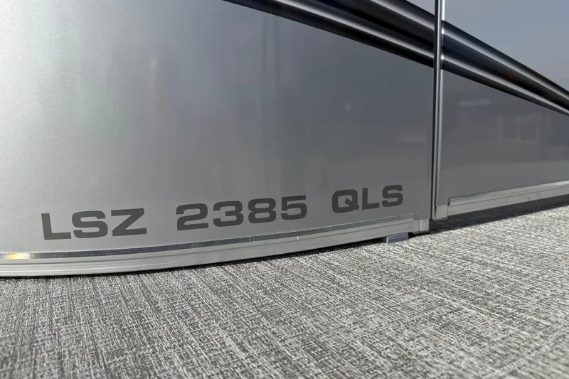 Slide: The Image of Silver Avalon LSZ 2385 QLS boat exterior, 2026 model, with sleek design details. - 57