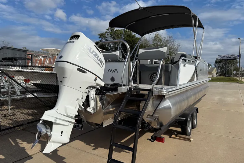 Slide: The Image of 2026 Avalon LSZ Quad Lounger Shift pontoon boat with Suzuki engine on trailer. - 8