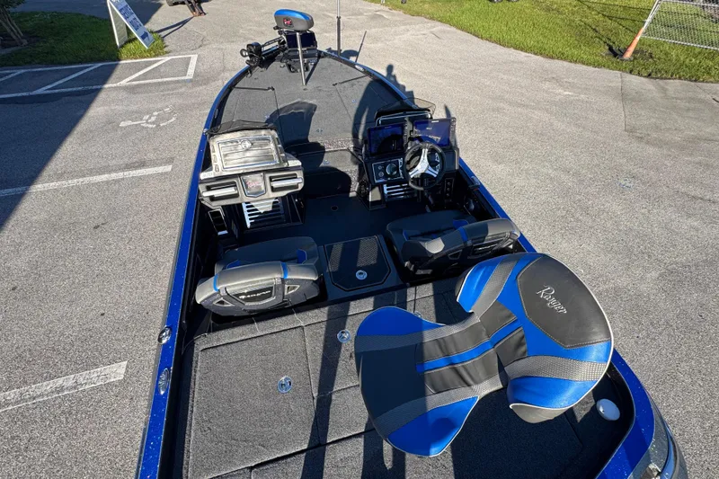 Slide: The Image of 2022 Ranger Z520R Cup-Equipped boat interior with blue and black seating. - 17