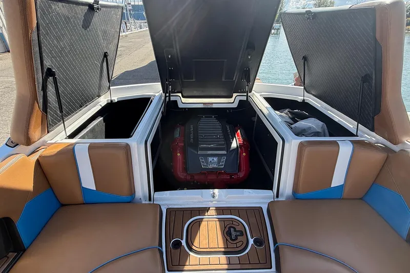 Slide: The Image of 2016 Nautique Super Air Nautique 230 engine compartment with open storage hatches. - 14