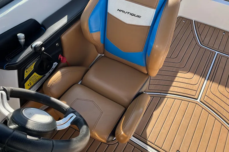 Slide: The Image of 2016 Nautique Super Air Nautique 230 cockpit with tan and blue seating. - 3