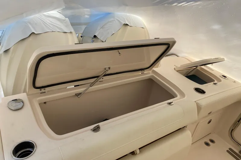 Slide: The Image of Open storage compartment on 2026 Grady-White Freedom 325 boat interior. - 12
