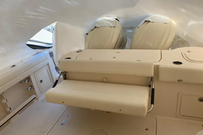 Slide: The Image of 2026 Grady-White Freedom 325 boat interior with seating and covered engines. - 13