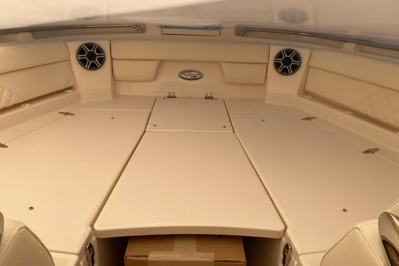 Slide: The Image of 2026 Grady-White Freedom 325 boat interior with cushioned seating and speakers. - 3