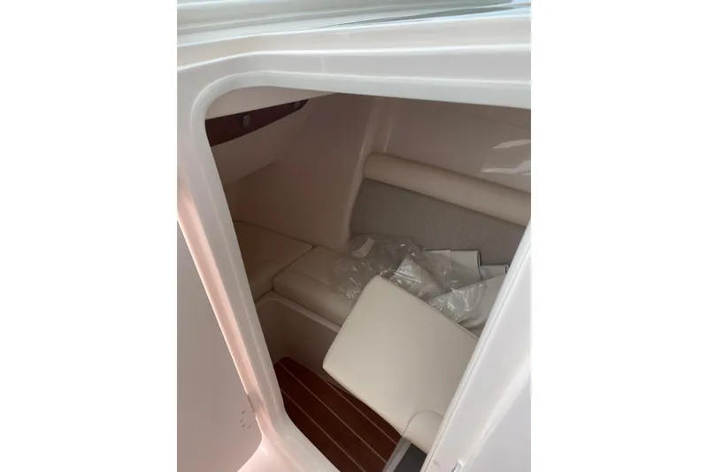 Slide: The Image of Interior cabin of 2026 Grady-White Freedom 325 boat, featuring cushioned seating. - 6