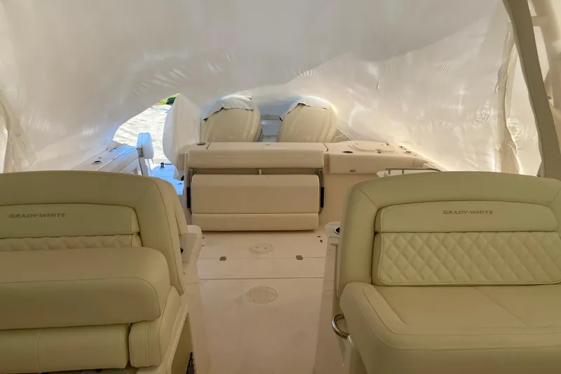 Slide: The Image of 2026 Grady-White Freedom 325 boat interior with luxurious seating and protective cover. - 8