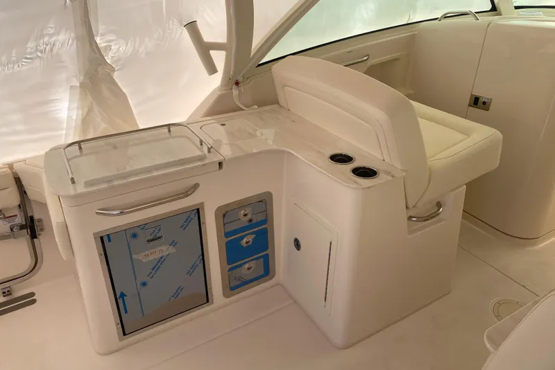 Slide: The Image of 2026 Grady-White Freedom 325 boat interior with seating and storage compartments. - 9