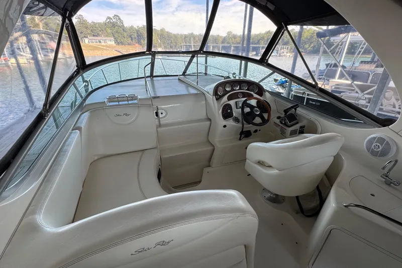 Slide: The Image of 2005 Sea Ray 280 Sundancer boat interior with helm, steering wheel, and seating. - 15
