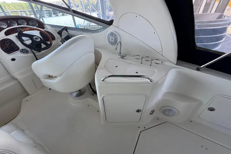 Slide: The Image of 2005 Sea Ray 280 Sundancer helm with steering wheel, controls, and seating. - 19
