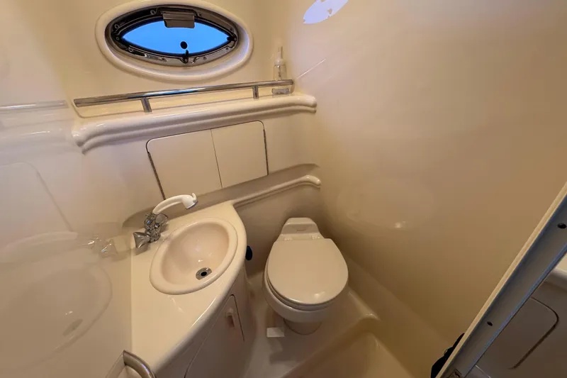 Slide: The Image of Compact bathroom in 2005 Sea Ray 280 Sundancer boat with sink and toilet. - 24
