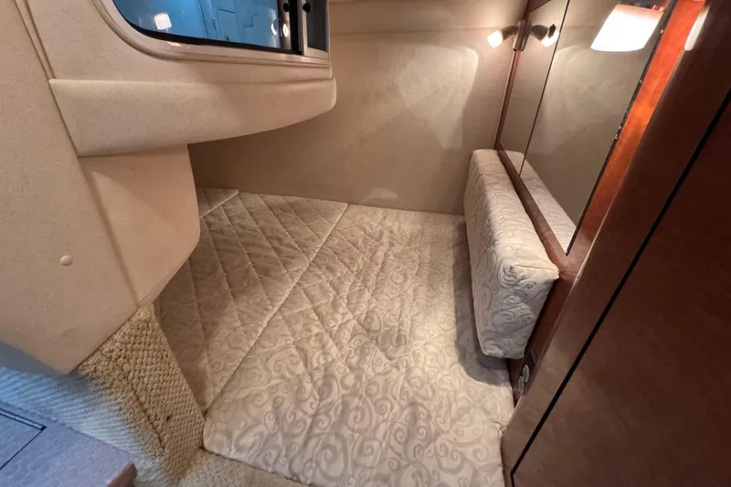 Slide: The Image of 2005 Sea Ray 280 Sundancer cabin interior with cozy bed and elegant lighting. - 25