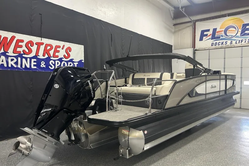 The Image of 2025 Barletta Lusso 25UE pontoon boat displayed indoors, featuring sleek design and luxury seating. - 0