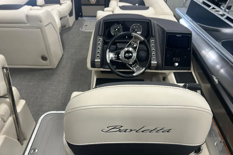 Slide: The Image of 2025 Barletta Lusso 25UE boat interior with luxurious seating and modern dashboard. - 12