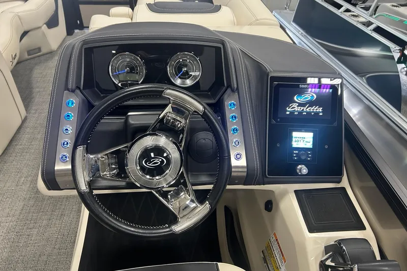 Slide: The Image of 2025 Barletta Lusso 25UE boat dashboard with steering wheel and digital display. - 14