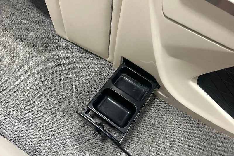 Slide: The Image of Barletta Lusso 25UE 2025 boat interior with retractable cup holders on textured flooring. - 15