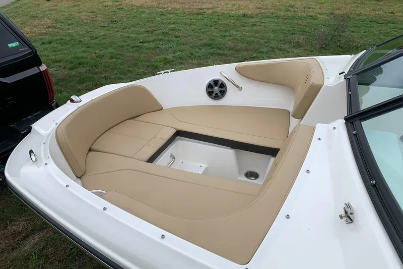 Slide: The Image of 2019 Sea Ray SPX 190 boat with beige seating and storage compartment. - 6