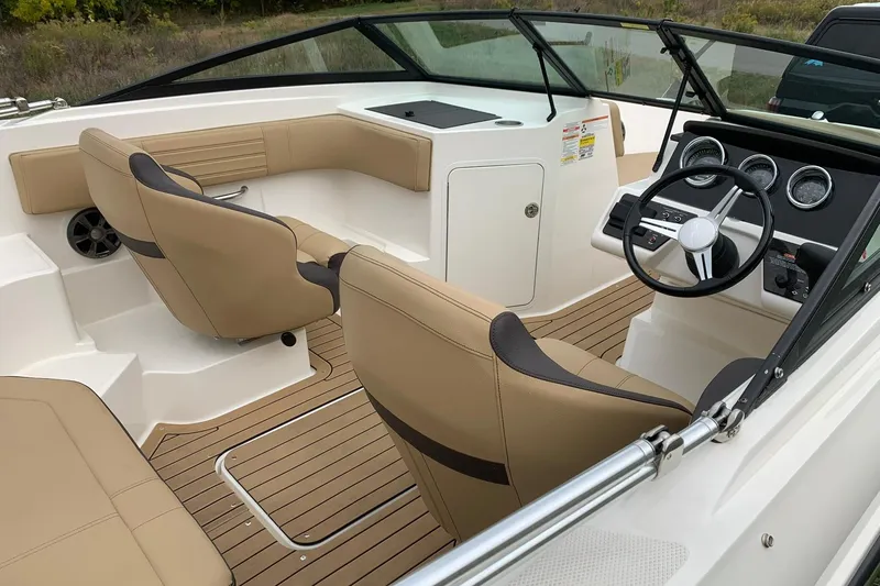 Slide: The Image of 2019 Sea Ray SPX 190 boat interior with tan seats and modern dashboard. - 7