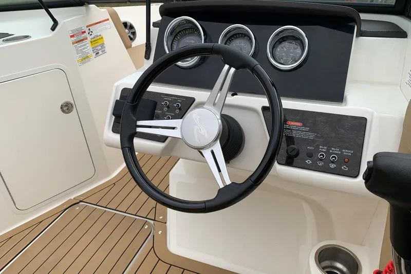 Slide: The Image of 2019 Sea Ray SPX 190 boat dashboard with steering wheel and control panel. - 9