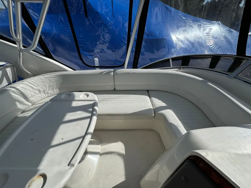 Slide: The Image of Interior view of a 2004 Meridian 381 Sedan yacht with white seating and table. - 12