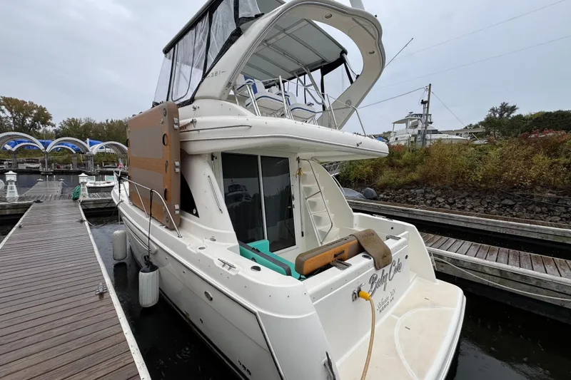 Slide: The Image of 2004 Meridian 381 Sedan yacht docked at a marina, rear view. - 2