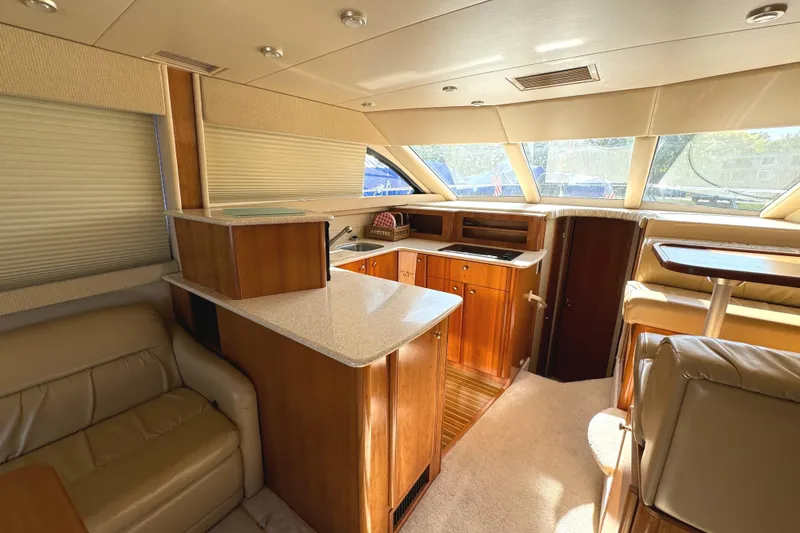 Slide: The Image of Luxurious interior of a 2004 Meridian 381 Sedan yacht with modern kitchen and seating area. - 20
