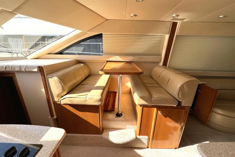 Slide: The Image of Luxurious interior of 2004 Meridian 381 Sedan with beige seating and wooden table. - 26