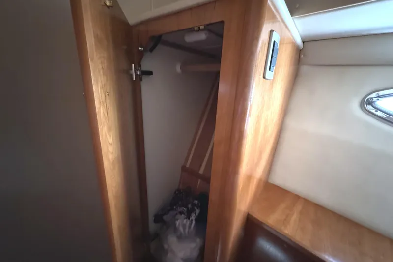 Slide: The Image of Interior view of a 2004 Meridian 381 Sedan boat closet with wooden finish. - 39