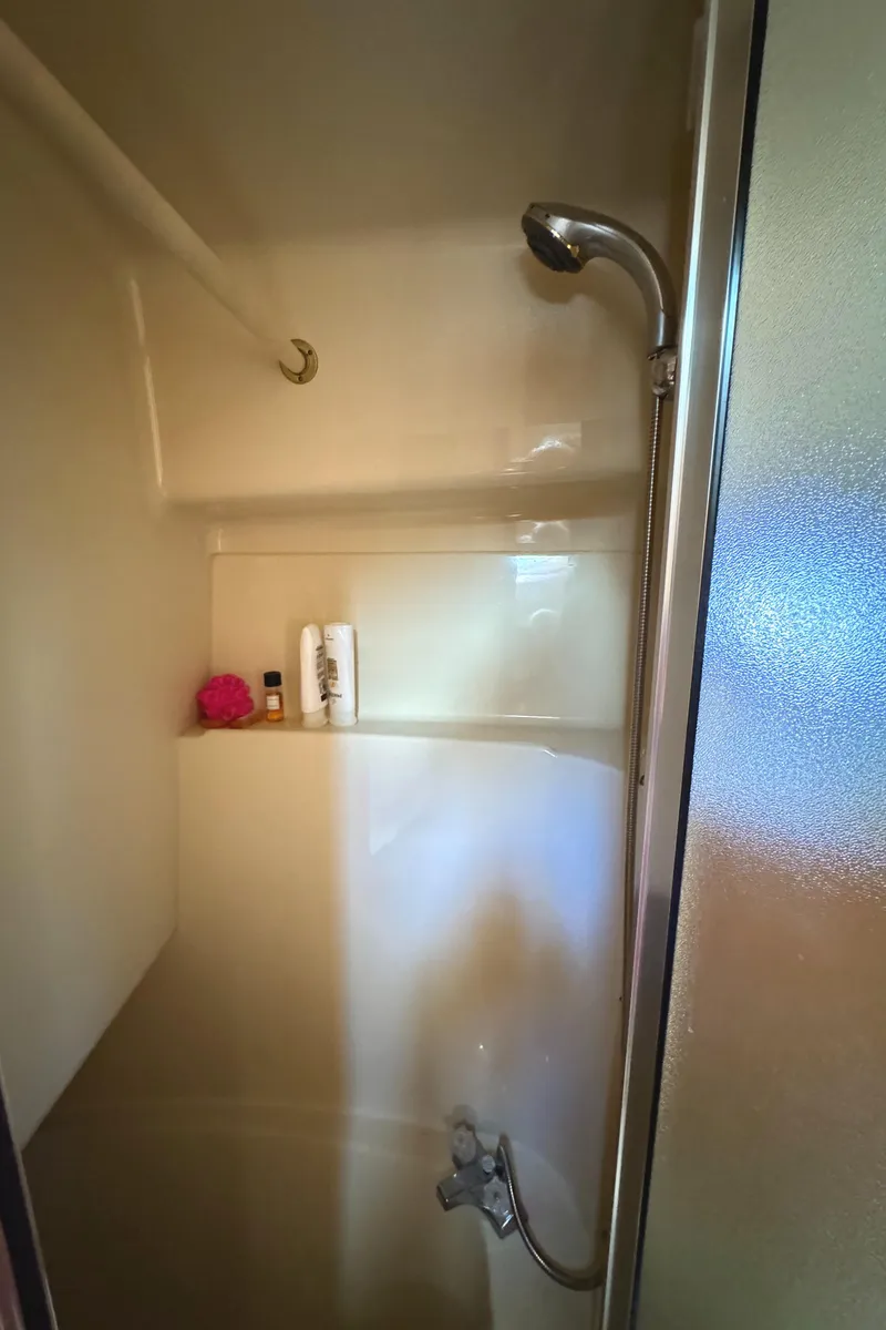 Slide: The Image of Shower area in 2004 Meridian 381 Sedan yacht with toiletries and showerhead. - 47