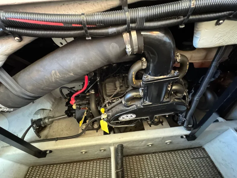 Slide: The Image of Engine compartment of a 2004 Meridian 381 Sedan boat, showcasing mechanical components and wiring. - 49