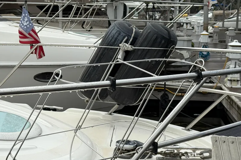 Slide: The Image of 2004 Meridian 381 Sedan yacht with fenders and American flag at marina. - 71
