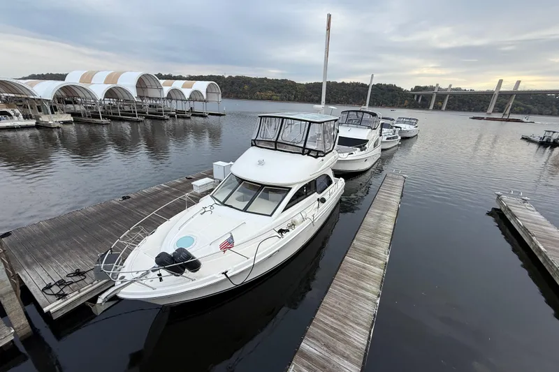 Slide: The Image of 2004 Meridian 381 Sedan yacht docked at marina with scenic bridge view. - 81