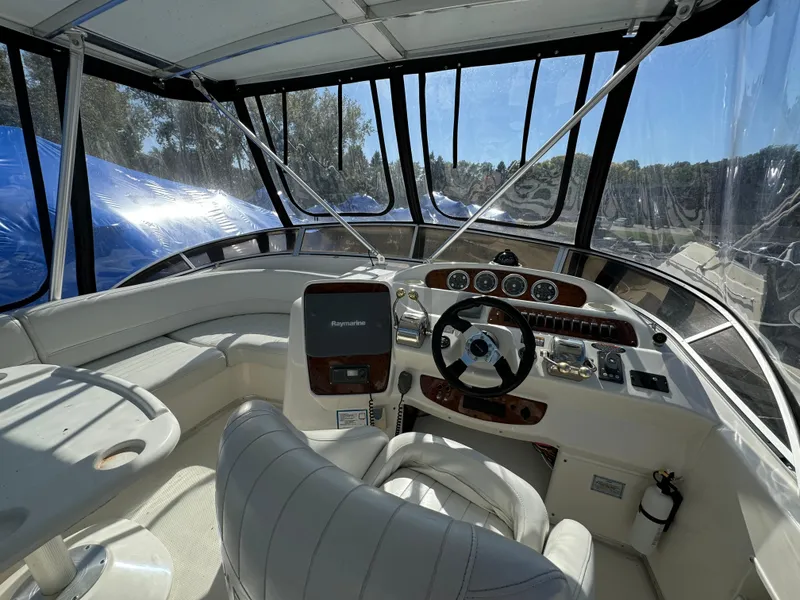 Slide: The Image of 2004 Meridian 381 Sedan boat cockpit with steering wheel, navigation controls, and seating. - 9