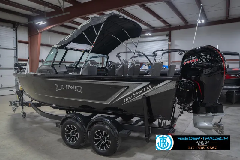 Slide: The Image of 2026 Lund 1875 Impact XS boat in showroom with Mercury Pro XS engine. - 10