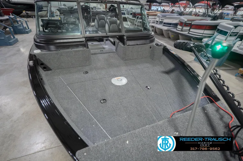 Slide: The Image of 2026 Lund 1875 Impact XS boat interior at Reeder-Trausch Marine showroom. - 13