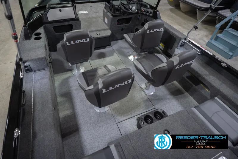 Slide: The Image of 2026 Lund 1875 Impact XS boat interior with four seats and steering console. - 15