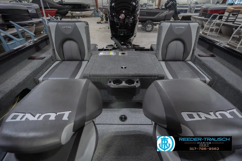 Slide: The Image of 2026 Lund 1875 Impact XS boat interior with gray seating and storage compartments. - 22