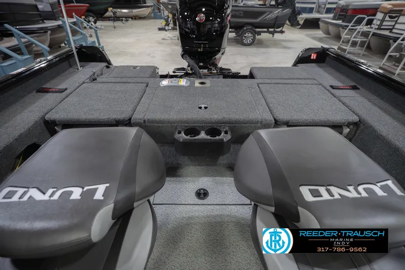 Slide: The Image of 2026 Lund 1875 Impact XS boat interior with seating and storage compartments. - 23