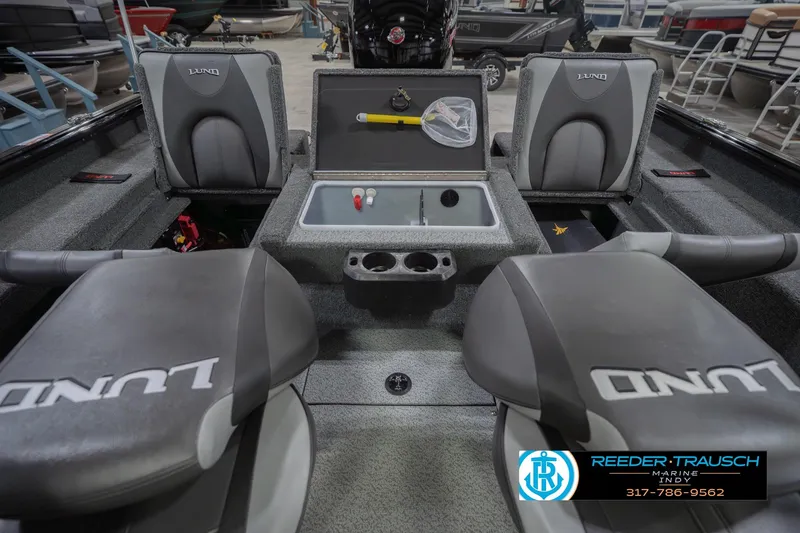 Slide: The Image of 2026 Lund 1875 Impact XS boat interior with seating and storage compartments. - 24