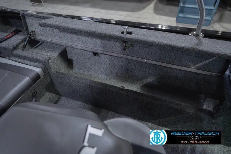 Slide: The Image of 2026 Lund 1875 Impact XS boat interior with seating and storage compartments. - 26