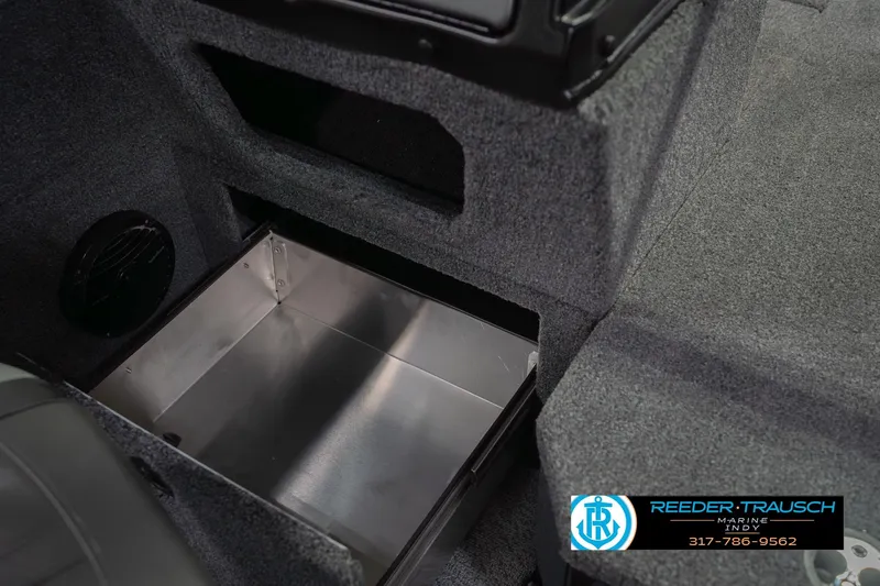 Slide: The Image of 2026 Lund 1875 Impact XS boat interior storage compartment with carpeted finish. - 28