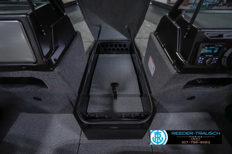 Slide: The Image of 2026 Lund 1875 Impact XS boat interior with storage compartment and control panel. - 30