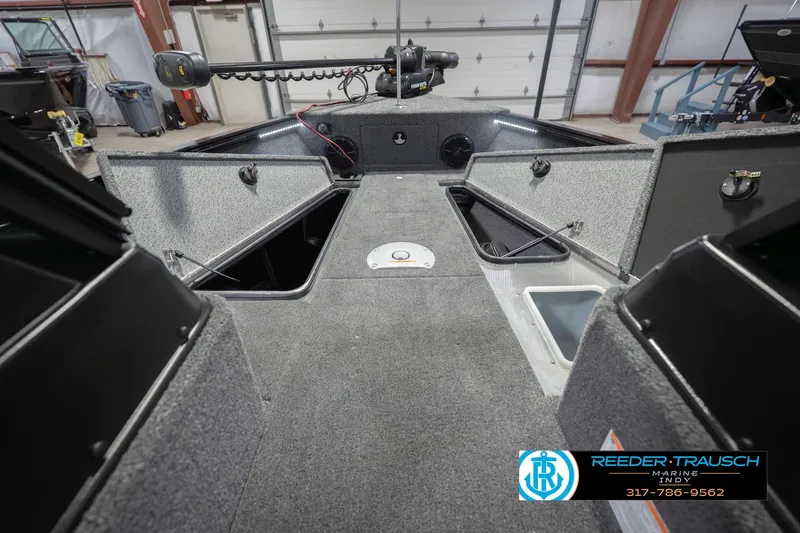 Slide: The Image of 2026 Lund 1875 Impact XS boat interior with storage compartments and fishing equipment. - 32