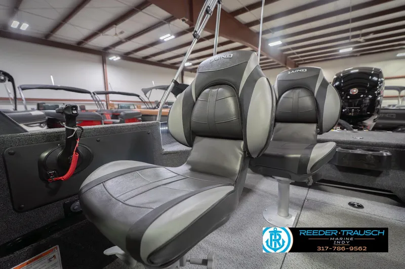 Slide: The Image of 2026 Lund 1875 Impact XS boat seats in showroom, featuring sleek design and comfortable seating. - 40