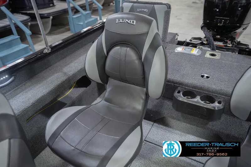 Slide: The Image of 2026 Lund 1875 Impact XS boat interior with gray seating and cup holders. - 42