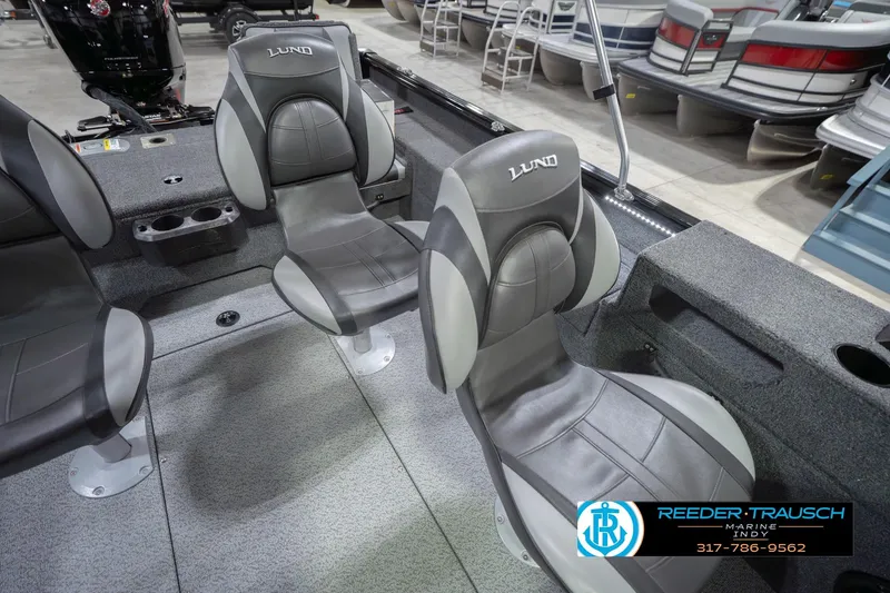 Slide: The Image of 2026 Lund 1875 Impact XS boat interior with gray seating and cup holders. - 44