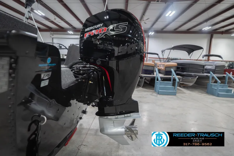 Slide: The Image of 2026 Lund 1875 Impact XS with Mercury Pro XS engine in showroom. - 49