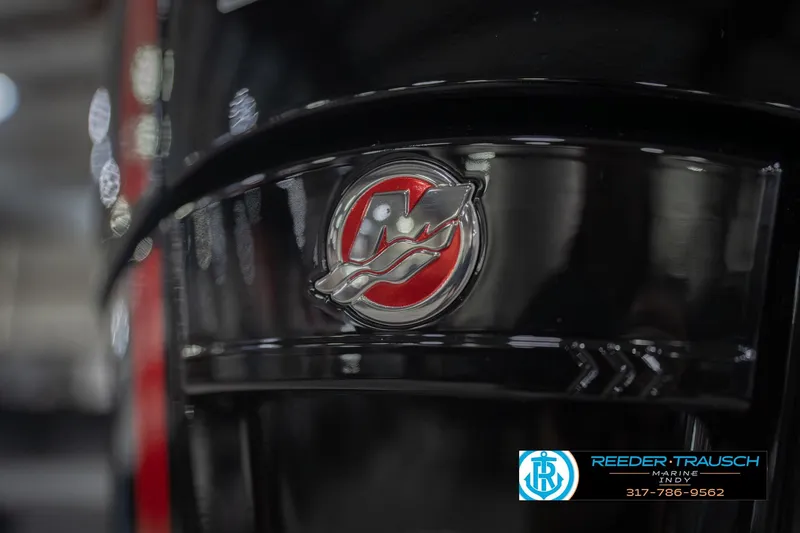 Slide: The Image of Close-up of 2026 Lund 1875 Impact XS boat logo with Reeder-Trausch Marine branding. - 52