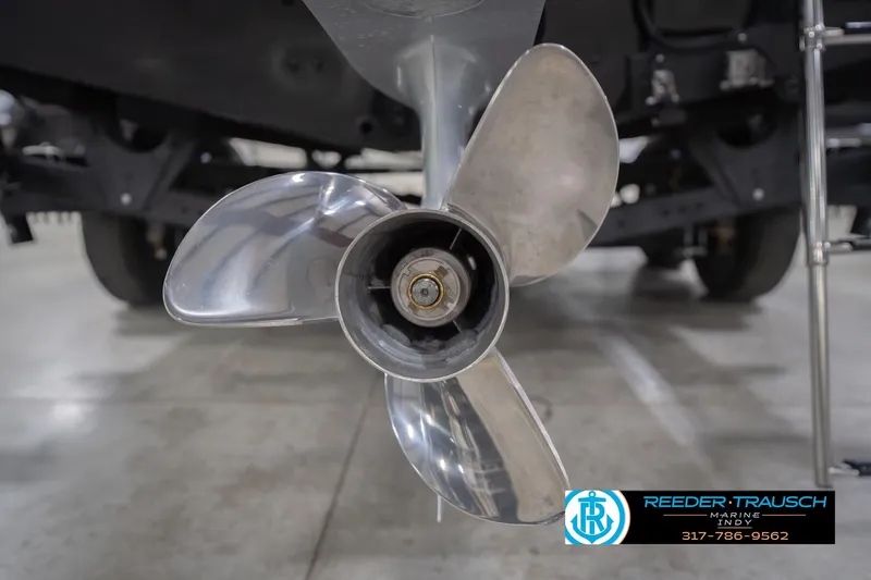 Slide: The Image of 2026 Lund 1875 Impact XS boat propeller in showroom, Reeder Trausch Marine logo visible. - 53
