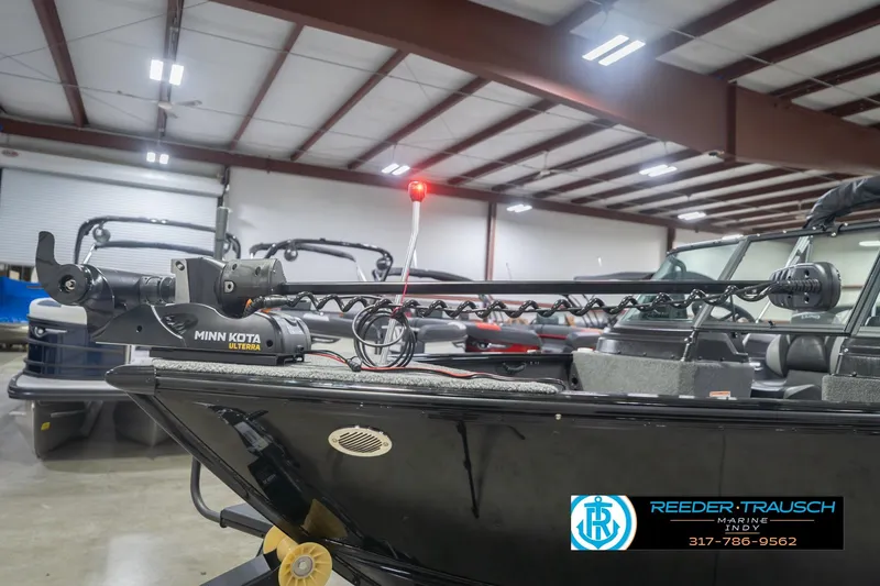 Slide: The Image of 2026 Lund 1875 Impact XS boat with Minn Kota Ulterra motor in showroom. - 54