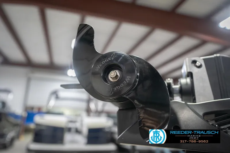 Slide: The Image of Close-up of a 2026 Lund 1875 Impact XS boat propeller in a showroom. - 57